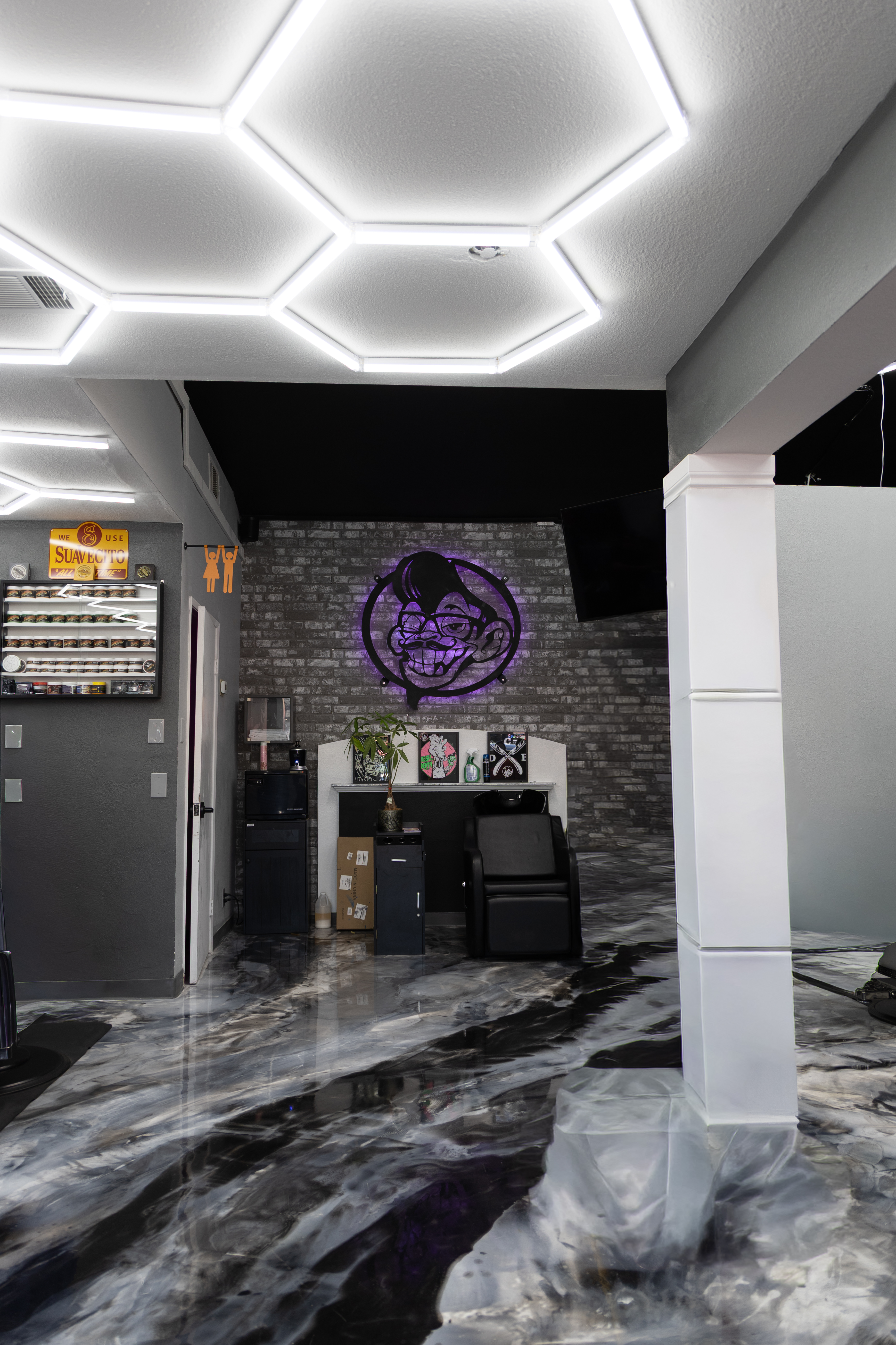 Hexagon ceiling lights and epoxy floor at Defined Cuts