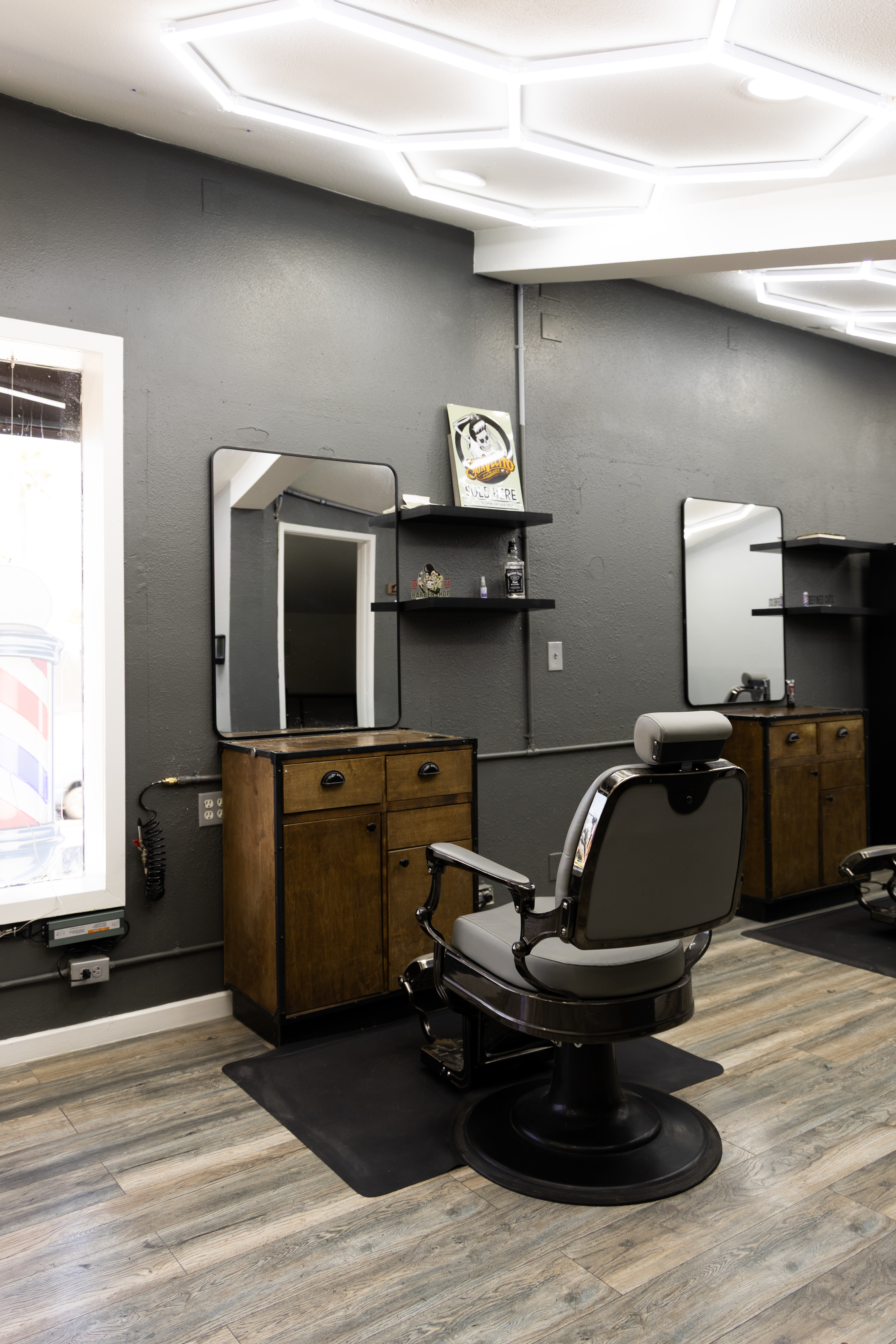 Empty barber chair and station at Defined Cuts